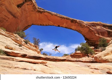 Man jumping inside of Owachomo Bridge in Natural Bridges National Monument, Utah - Powered by Shutterstock