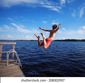 Man jumping off jetty.