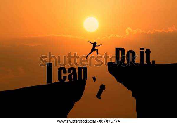 Man jumping on I can do\
it or I can\'t do it text over cliff on sunset background,Business\
concept idea