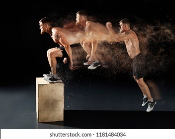 Man Jumping On Fit Box In Gym. Male With Naked Torso Exercises Jump On The Dark Background