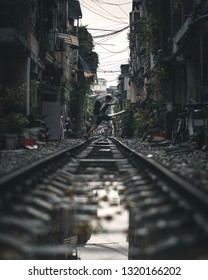 Man Jumping Over Train Track In Hanoi Vietnam