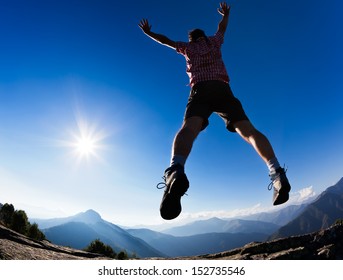 Man jumping in the sunshine against blue sky. Concept: freedom, success, energy, vitality. - Shutterstock ID 152735546