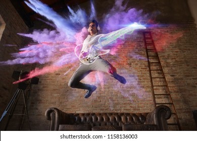 man jumps with colorful background playing a virtual guitar. concept of freedom and creativity with music
 - Powered by Shutterstock