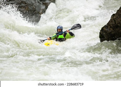 Man kayaking down class IV Boulder Drop rapid on the Skykomish River in Washington State.  - Powered by Shutterstock