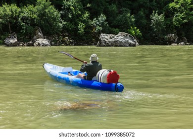 Man Kayaking On The River