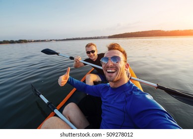 Man Kayaking At Sunset