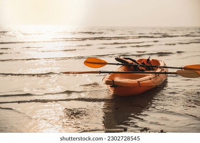 Man kayaking at sunset sea, kayaking, canoeing, boating. Man playing on the beach with kayak at the day time. People having fun outdoors. Concept of summer vacation . - Powered by Shutterstock