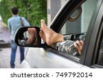 Man keep his legs through car window