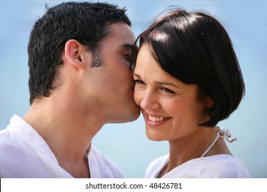 Man Kissing Woman On Cheek