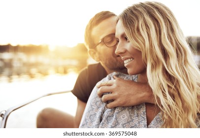 Man Kissing Woman while Woman Smiling Gently