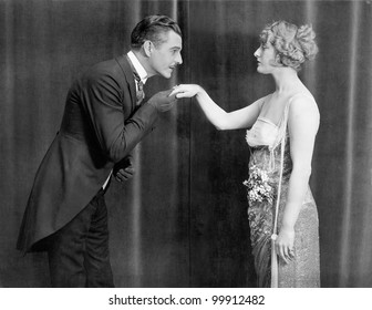 Man kissing womans hand