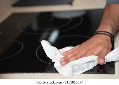 Man in the kitchen cleaning a ceramic hob