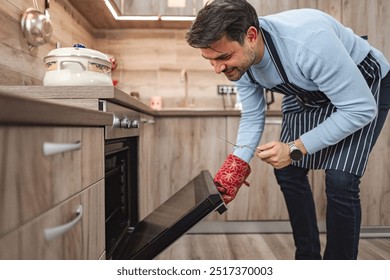 Man in the kitchen preparing lunch in the oven - Powered by Shutterstock