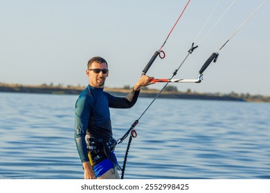 Man kitesurfing on calm water, creating splashes and showcasing the excitement of extreme water sports - Powered by Shutterstock