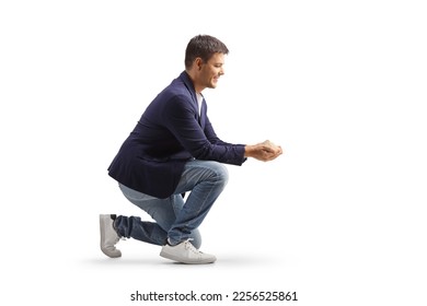Man kneeling and holding a dust in his hands isolated on white background