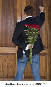 Man Knocking On Door To Present Flowers To His Date On Valentines Day