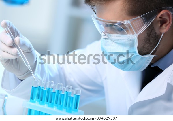 man-laboratory-checking-test-tubes-stock-photo-edit-now-394529587