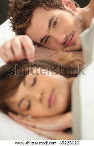 Similar – Image, Stock Photo Young couple in love embracing lying over a bed