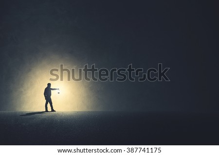 Man with lamp walking illuminating his path