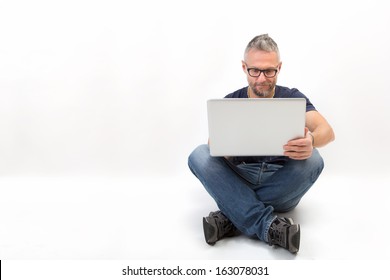 Man with a laptop - isolated sitting over a white background