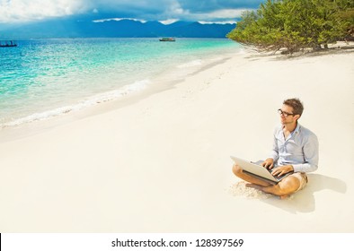 Man With Laptop On Colorful Beach Of Island