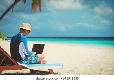 Man With Laptop On Tropical Beach