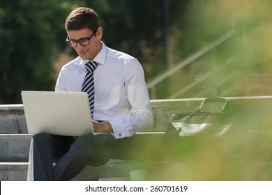 Man With Laptop At Summer Park On Bright Day