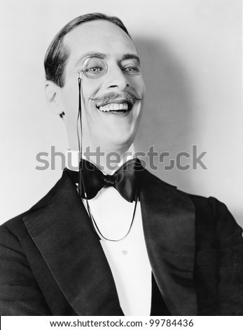 Man laughing and a monocle