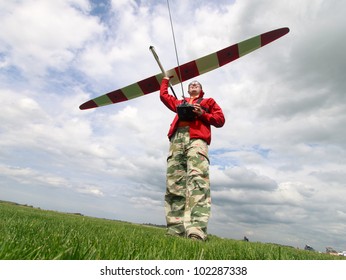 Man launches into the sky RC glider, wide-angle