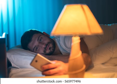 The Man Lay On The Bed And Phone