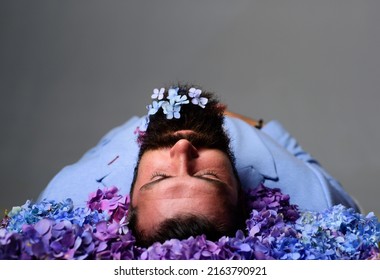 Man Laying In Flowers. Dead Body. Bearded Man With Lay With Closed Eyes.