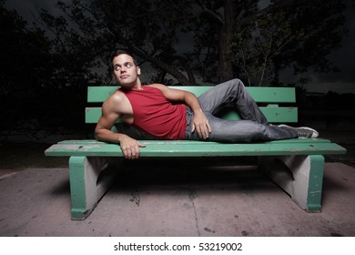 Man laying on a bench