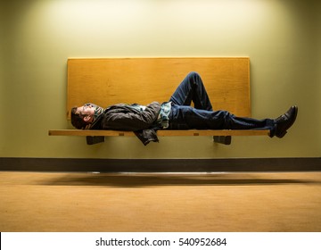 Man Laying On Bench Eyes Open Thinking.