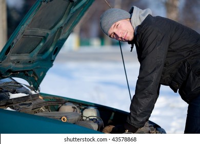 Man Lean Against Broken Car In Winter