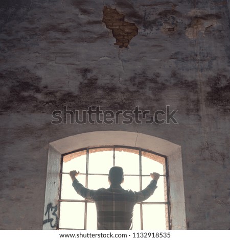 man leaning on window