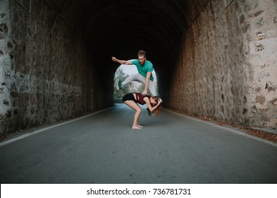 Man Leapfrog Jumping Over Woman On A Road.