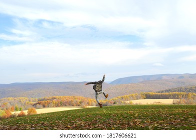 A Man Leaping Into The Air In Celebration Near Kentuck Knob In Pennsylvania