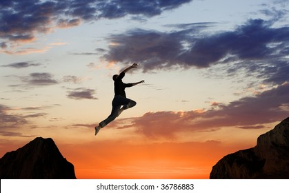 Man Leaping Mid-air on Mountainside
