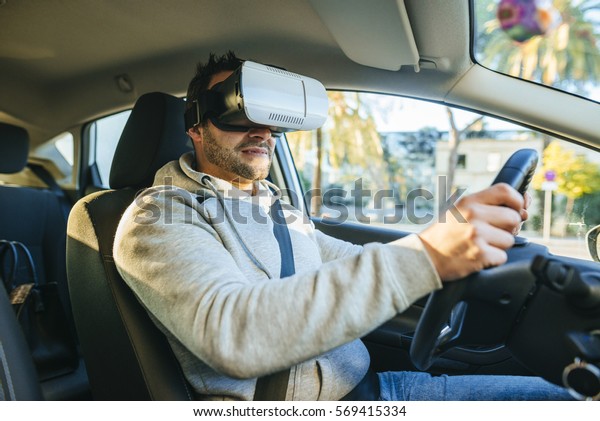 Man\
learning to drive with virtual reality\
glasses.