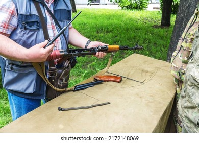 A Man Is Learning How To Assemble A Machine Gun On A Military Training Course