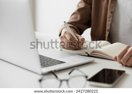 Man learning online, has web conference meeting, student using laptop, distance education