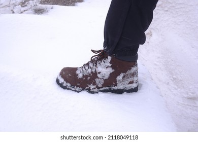 Man With Leather Boot With Snowy Background. Hiking In Winter.