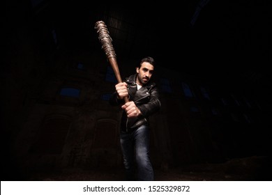 man in leather jacket and baseball bat
