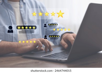 Man leaving service feedback using laptop at table, closeup. Reviews and stars near device - Powered by Shutterstock