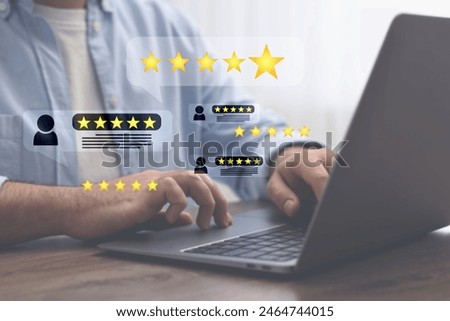 Man leaving service feedback using laptop at table, closeup. Reviews and stars near device