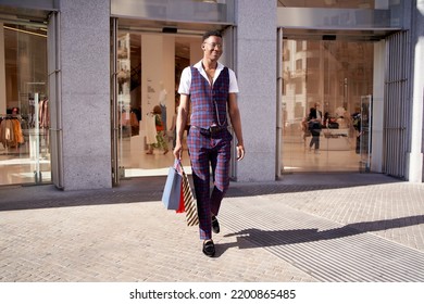 Man Leaving Store With Shopping Bags