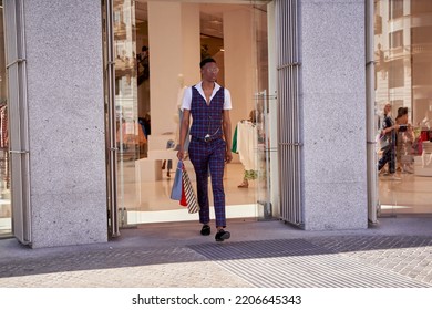 Man Leaving Store With Shopping Bags