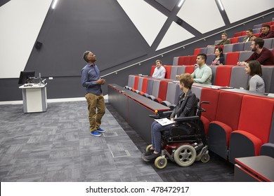Man lecturing students in a university lecture theatre