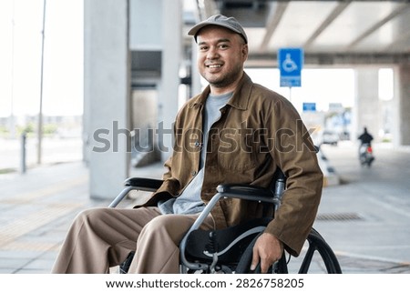 A man with a leg disability who cannot walk uses a wheelchair and travels by the train at a station He walks along the sidewalk where there are signs indicating accessibility for disabled individuals