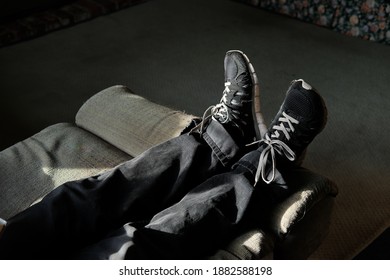 Man Legs On A Recliner Chair In A Living Room
